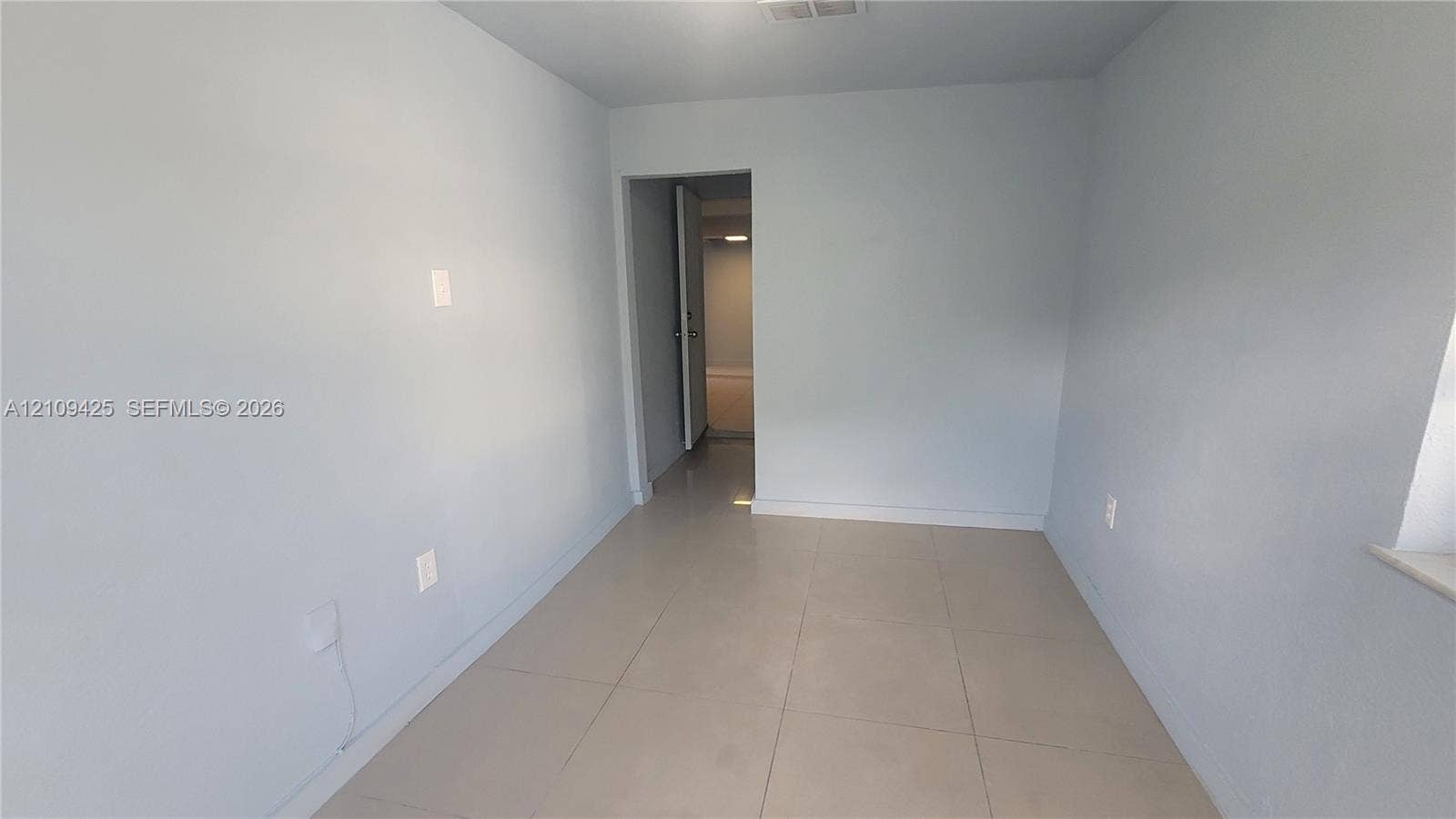 615 NW 25th Court, #B, Miami, Miami, FL 33125 Neutral-toned wall finish with large-format ceramic tile flooring