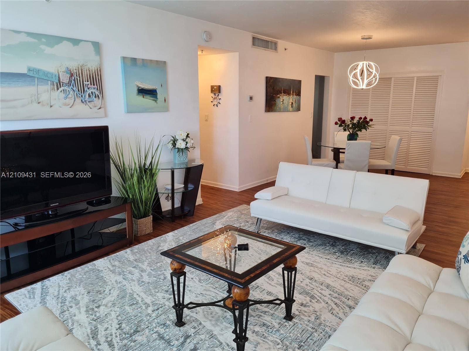 3001 S Ocean Drive, #619, Hollywood, Hollywood, FL 33019 Wood-finish flooring, white louvered closet doors, and a contemporary geometric pendant light fixture