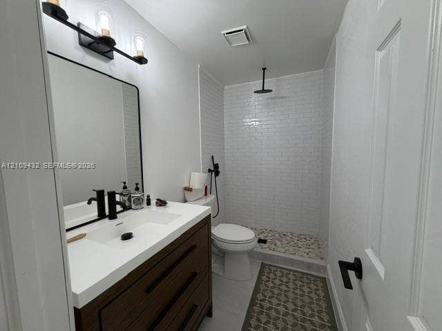 254 NW 107th Terrace, Coral Springs, FL 33071 Bathroom featuring a dark wood-finish vanity with a white countertop, matte black fixtures, a walk-in shower with white subway tile, and stone-tiled shower flooring