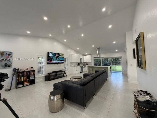 254 NW 107th Terrace, Coral Springs, FL 33071 Vaulted ceilings featuring recessed lighting, large-format tile flooring, kitchen island with built-in cabinetry, and sliding glass doors