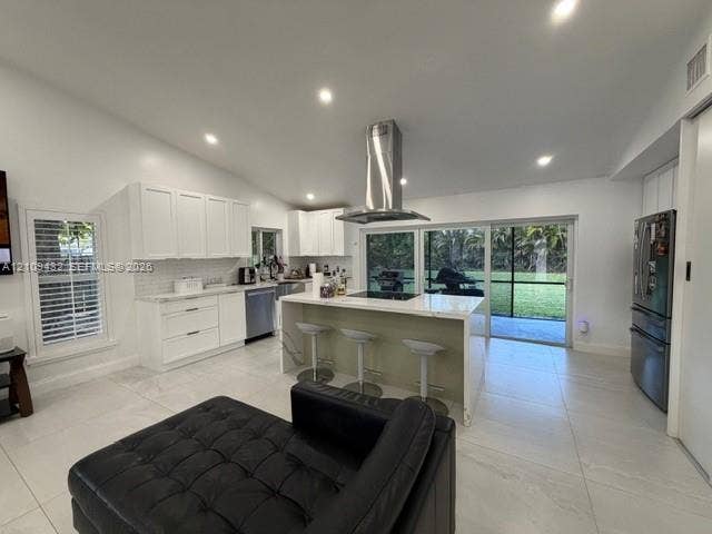 254 NW 107th Terrace, Coral Springs, FL 33071 Kitchen featuring white shaker-style cabinetry, quartz countertops, a central island with a built-in cooktop, stainless steel range hood, and large-format tile flooring