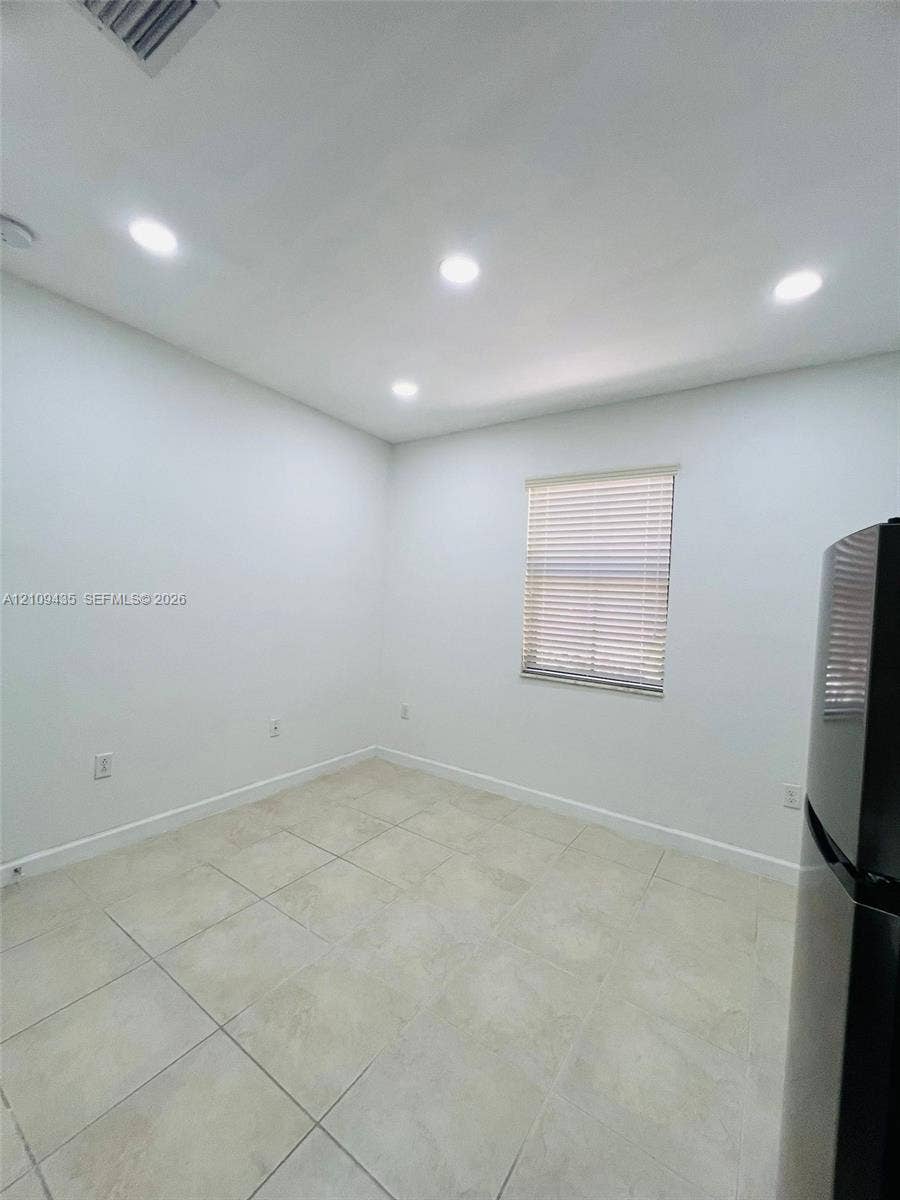 24161 SW 115th Court, #1, Homestead, Homestead, FL 33032 Neutral-toned tile flooring, recessed ceiling lighting, and a window with horizontal blinds