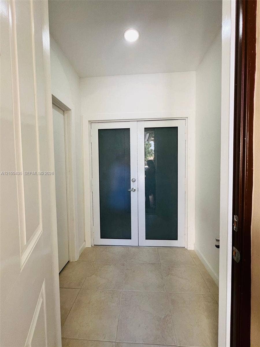 24161 SW 115th Court, #1, Homestead, Homestead, FL 33032 Double-entry doors with opaque glass panels, light-toned ceramic tile flooring, and a ceiling-mounted flush light fixture