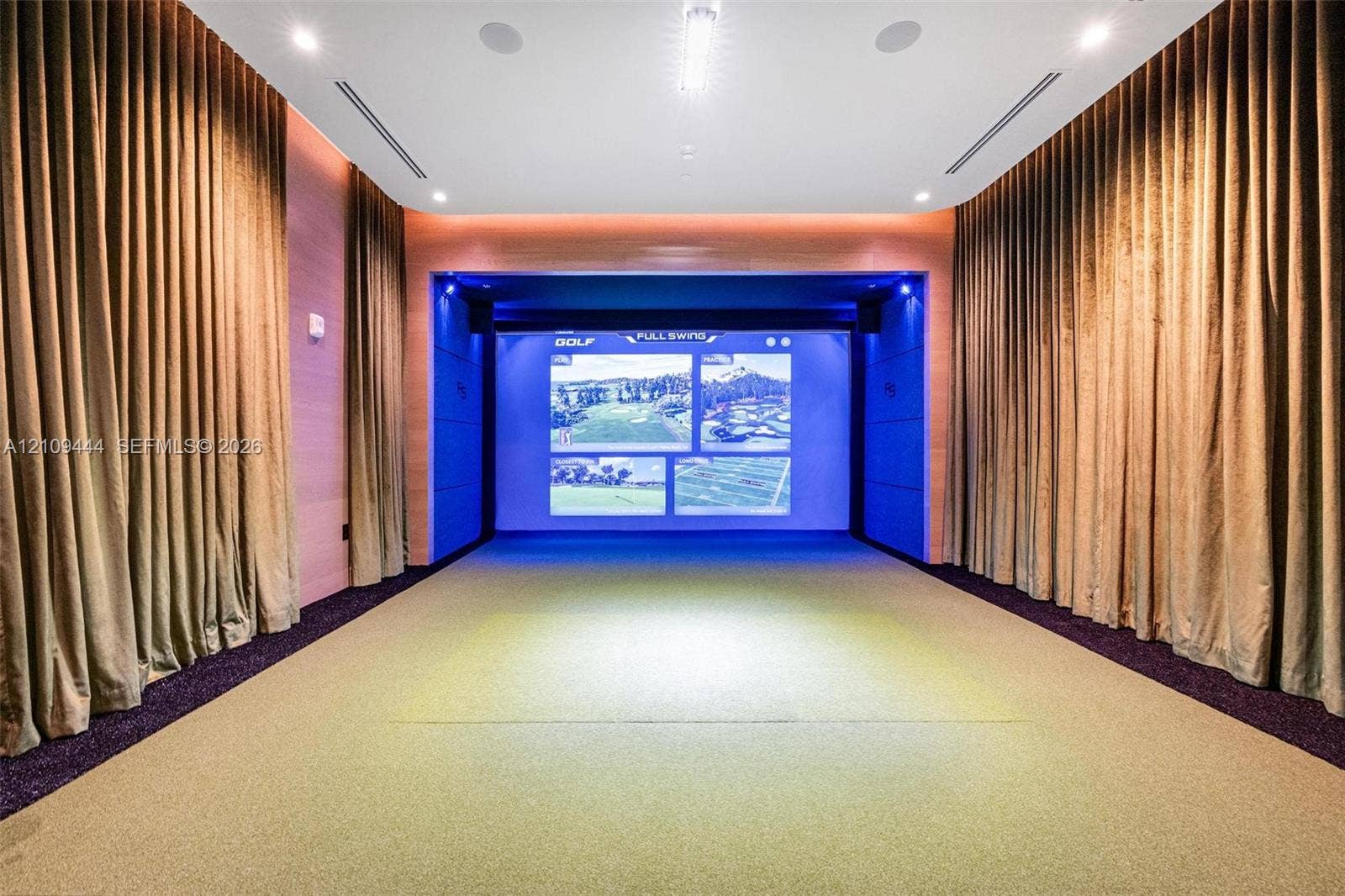 Recreation room featuring an integrated projection system, recessed ceiling lighting, surround sound speakers, and acoustic wall paneling