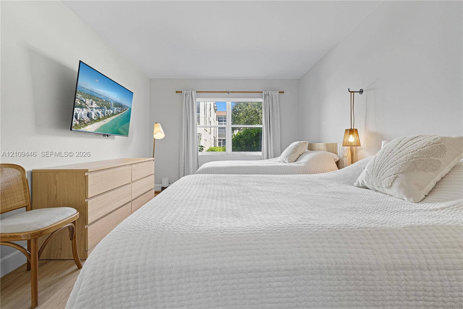 1501 S Ocean Boulevard, #117, Lauderdale-By-The-Sea, Lauderdale By The Sea, FL 33062 Neutral-toned bedroom featuring wood-finish flooring and a central window with white trim