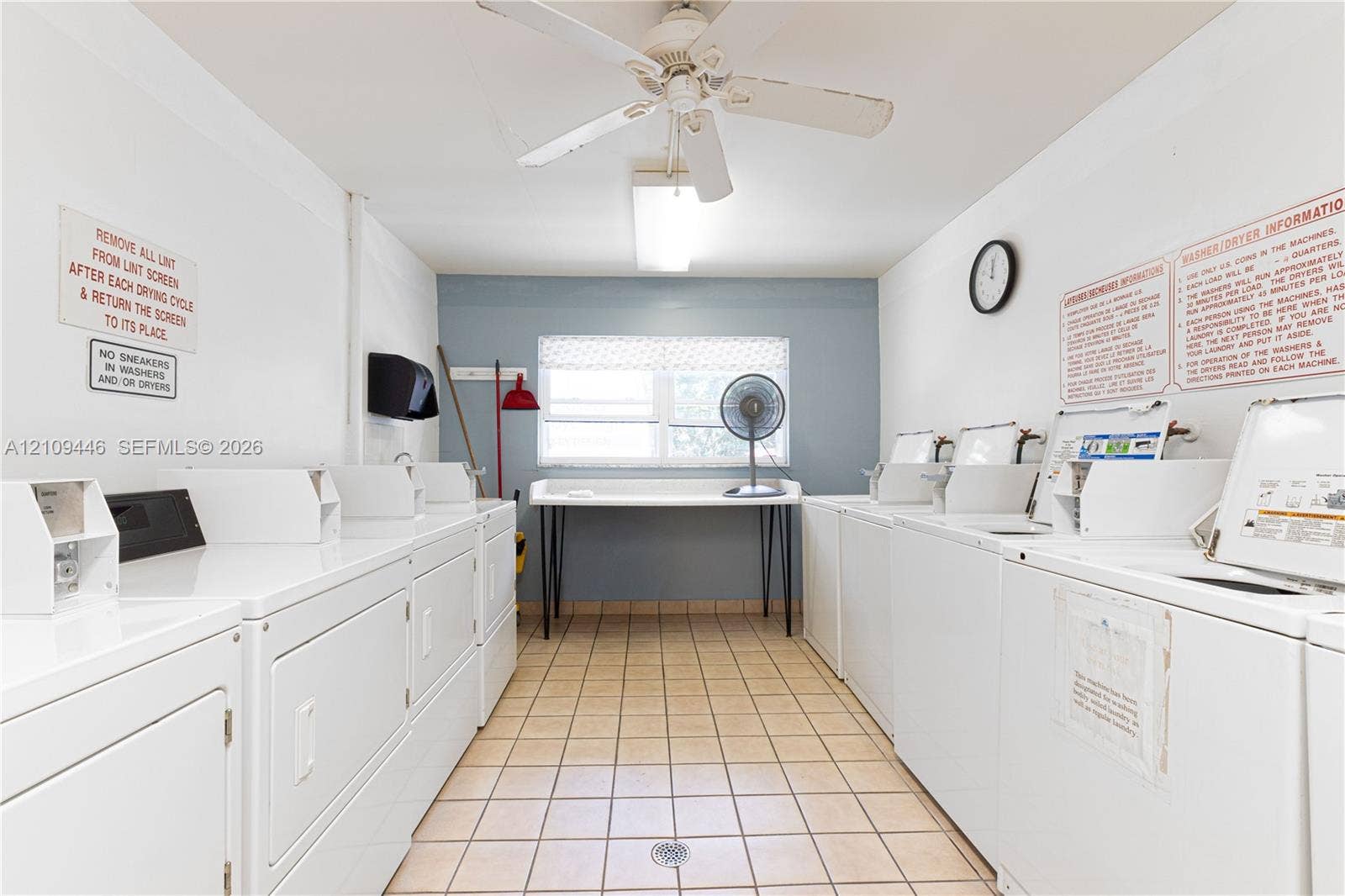 1501 S Ocean Boulevard, #117, Lauderdale-By-The-Sea, Lauderdale By The Sea, FL 33062 Laundry facility featuring multiple washer and dryer units, tile flooring, built-in counter space, and a ceiling fan
