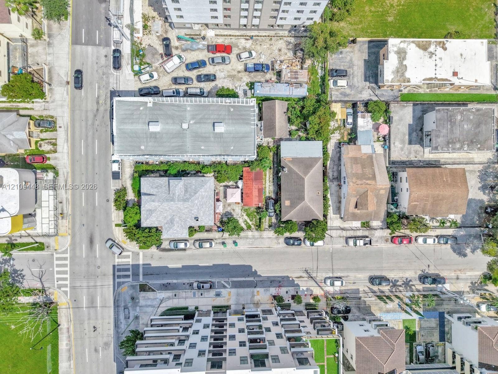 676 SW 1st Street, Miami, FL 33130 Aerial perspective featuring a multi-story residential structure, paved street access, and dense urban surroundings