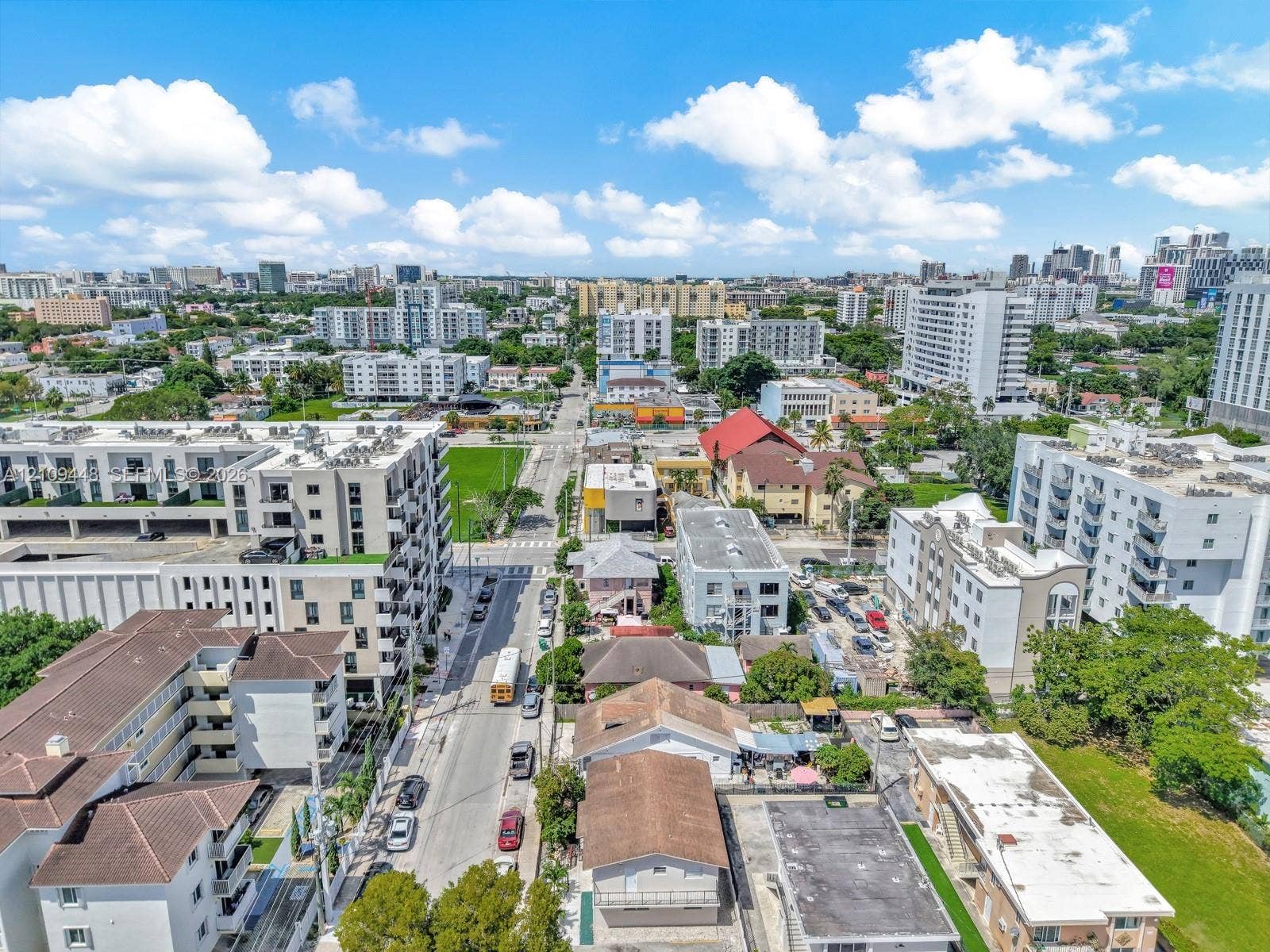 676 SW 1st Street, Miami, FL 33130 Aerial perspective of a dense urban environment featuring multi-story residential buildings, paved street infrastructure, and varied roofing materials