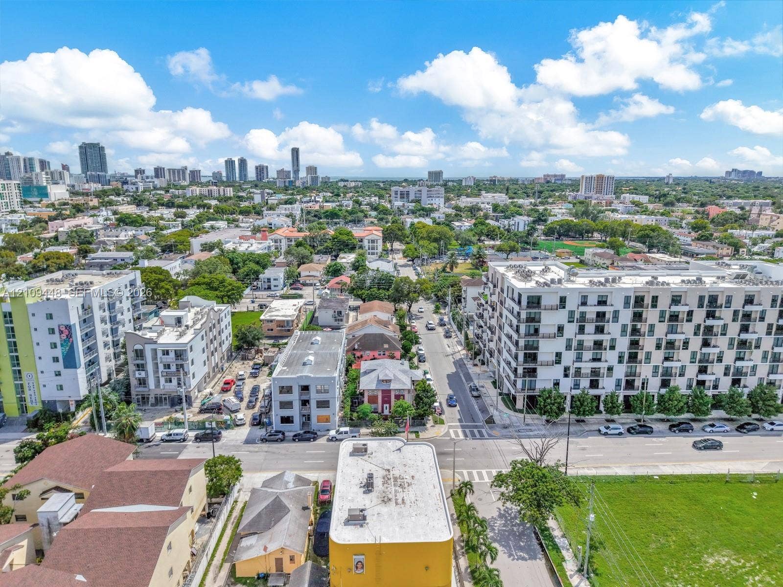 676 SW 1st Street, Miami, FL 33130 Aerial perspective of the urban landscape featuring multi-story residential architecture, paved roadways, and a metropolitan skyline backdrop