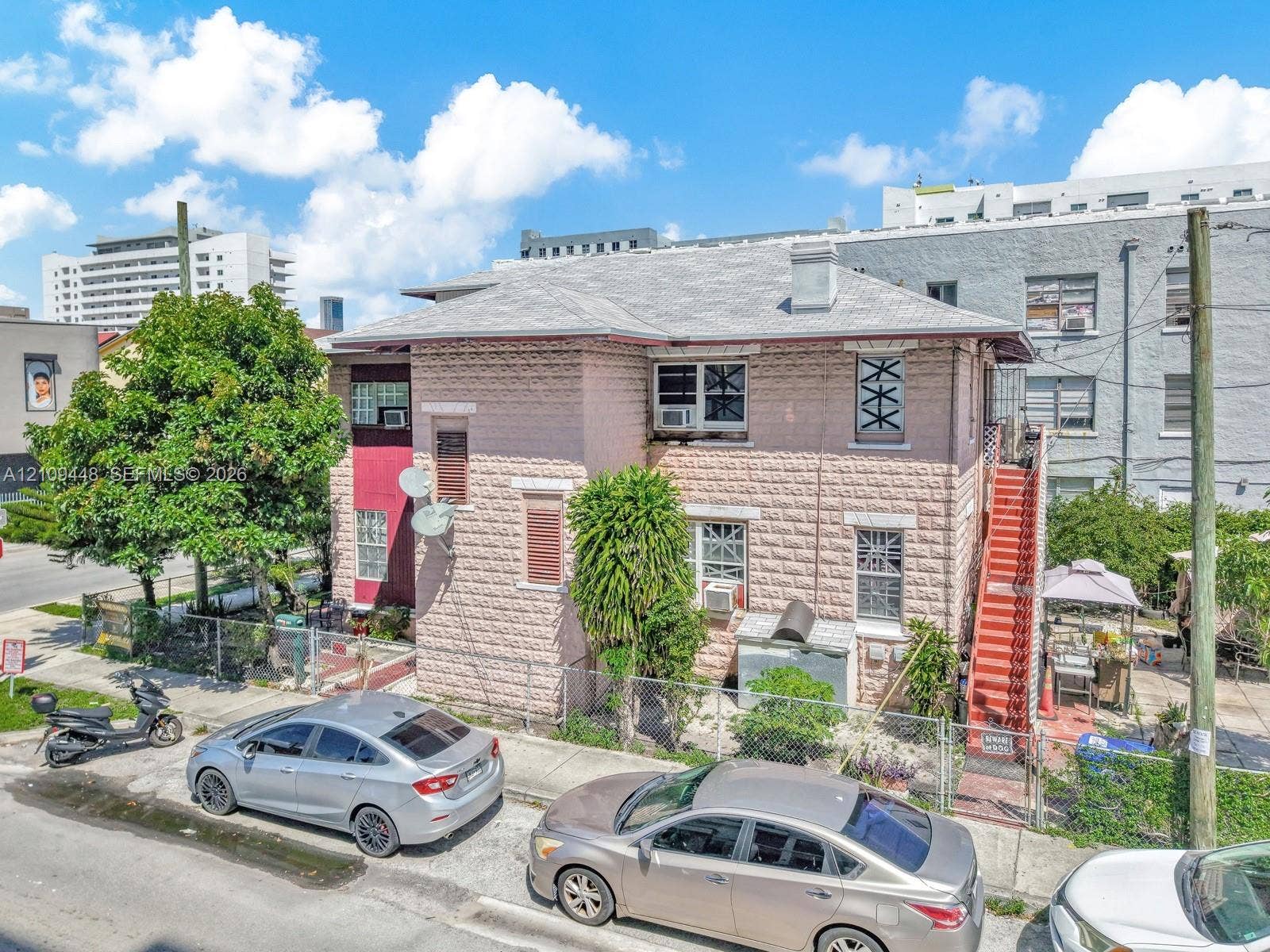 676 SW 1st Street, Miami, FL 33130 Two-story exterior featuring masonry construction, a hip roof, and an external staircase