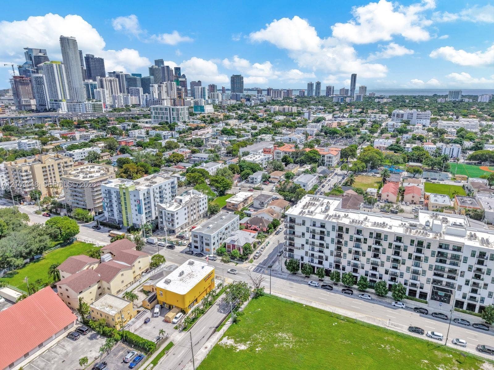 676 SW 1st Street, Miami, FL 33130 Aerial perspective of the urban landscape featuring multi-story residential buildings, paved street grids, and proximity to the city skyline
