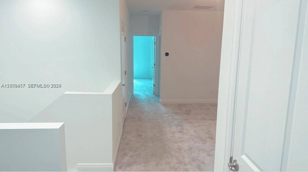 Neutral wall palette, carpeting, and multi-panel doors