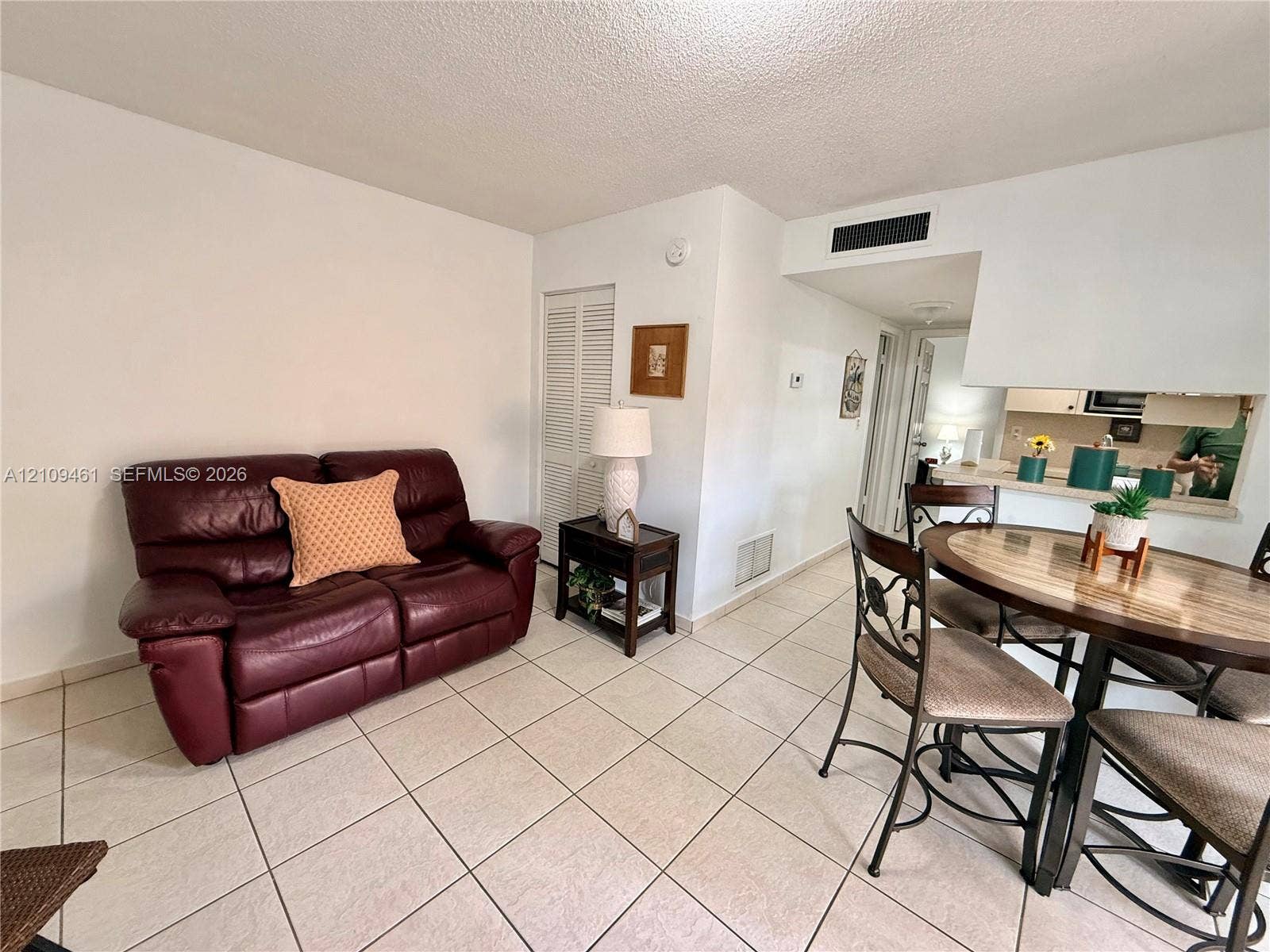 10776 N Kendall Drive, #F11, Miami, FL 33176 Neutral tile flooring and louvered closet doors