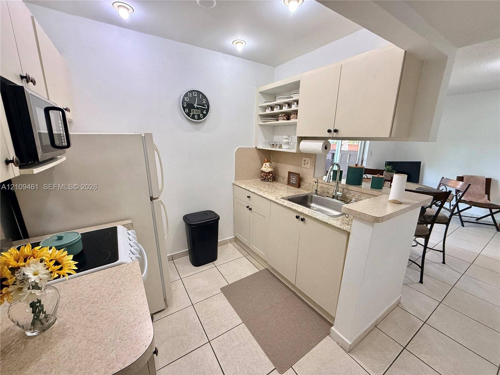 10776 N Kendall Drive, #F11, Miami, FL 33176 Kitchen featuring light-toned cabinetry, solid surface countertops, a stainless steel undermount sink, recessed lighting, and tile flooring
