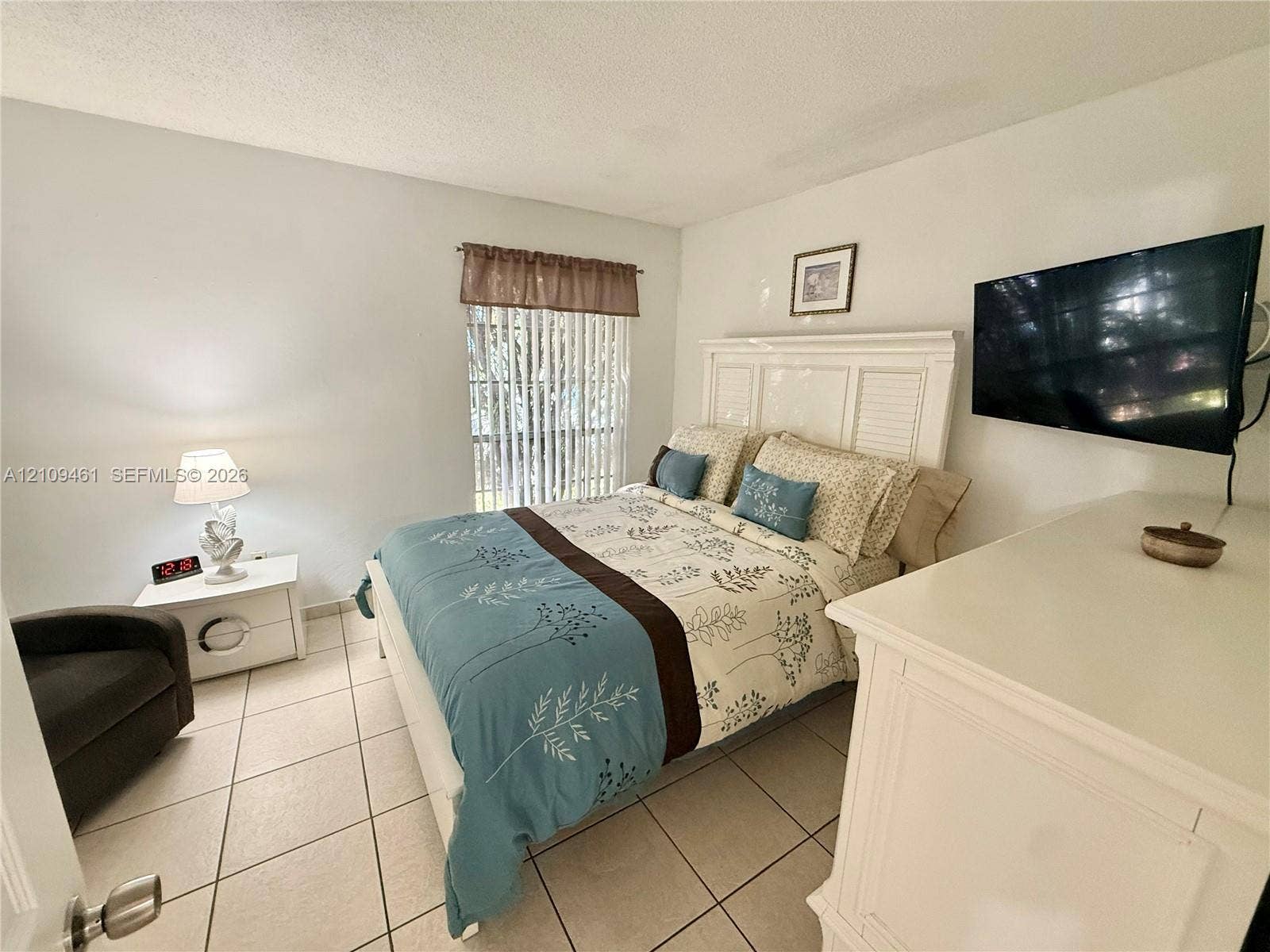 10776 N Kendall Drive, #F11, Miami, FL 33176 Neutral-toned tile flooring and vertical window blinds