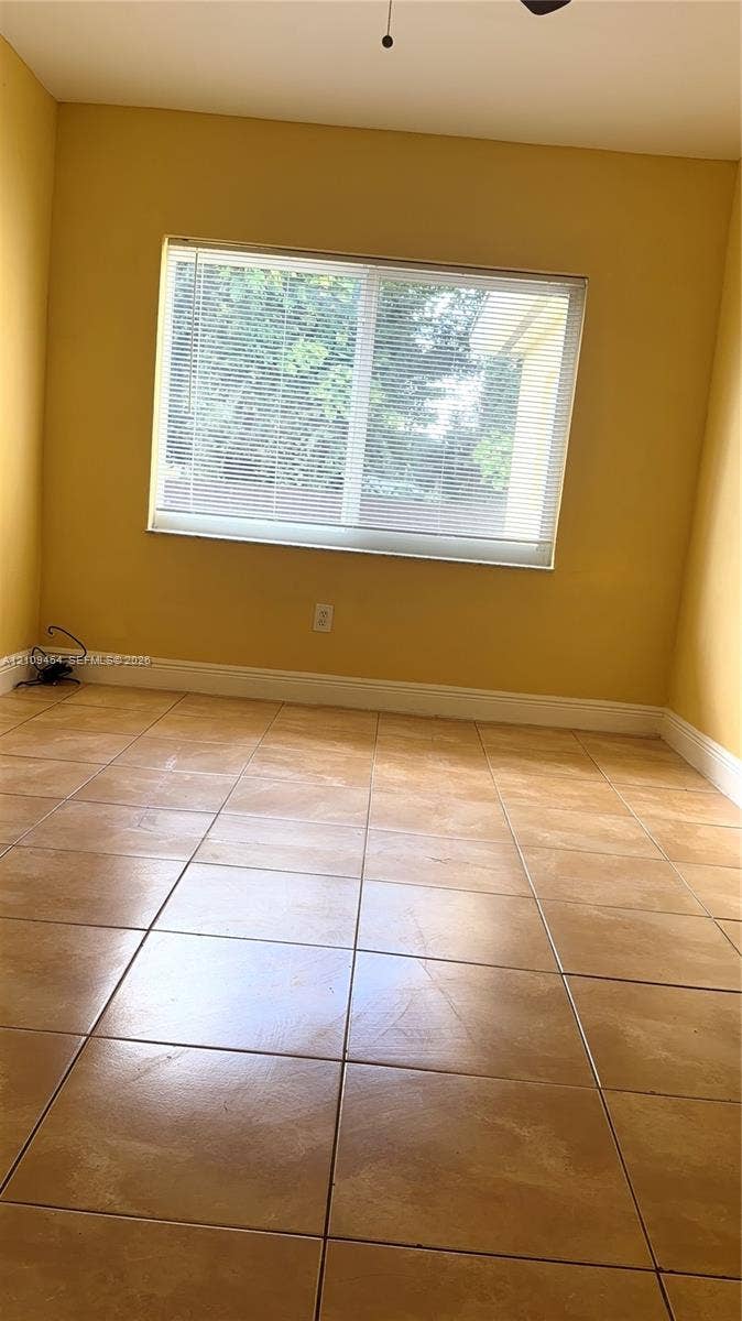 Room featuring large-format ceramic tile flooring and a dual-pane horizontal sliding window