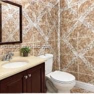 Vanity featuring a solid-surface countertop with an integrated oval basin and dark wood-finish cabinetry, complemented by decorative geometric wall tile and a framed wall mirror