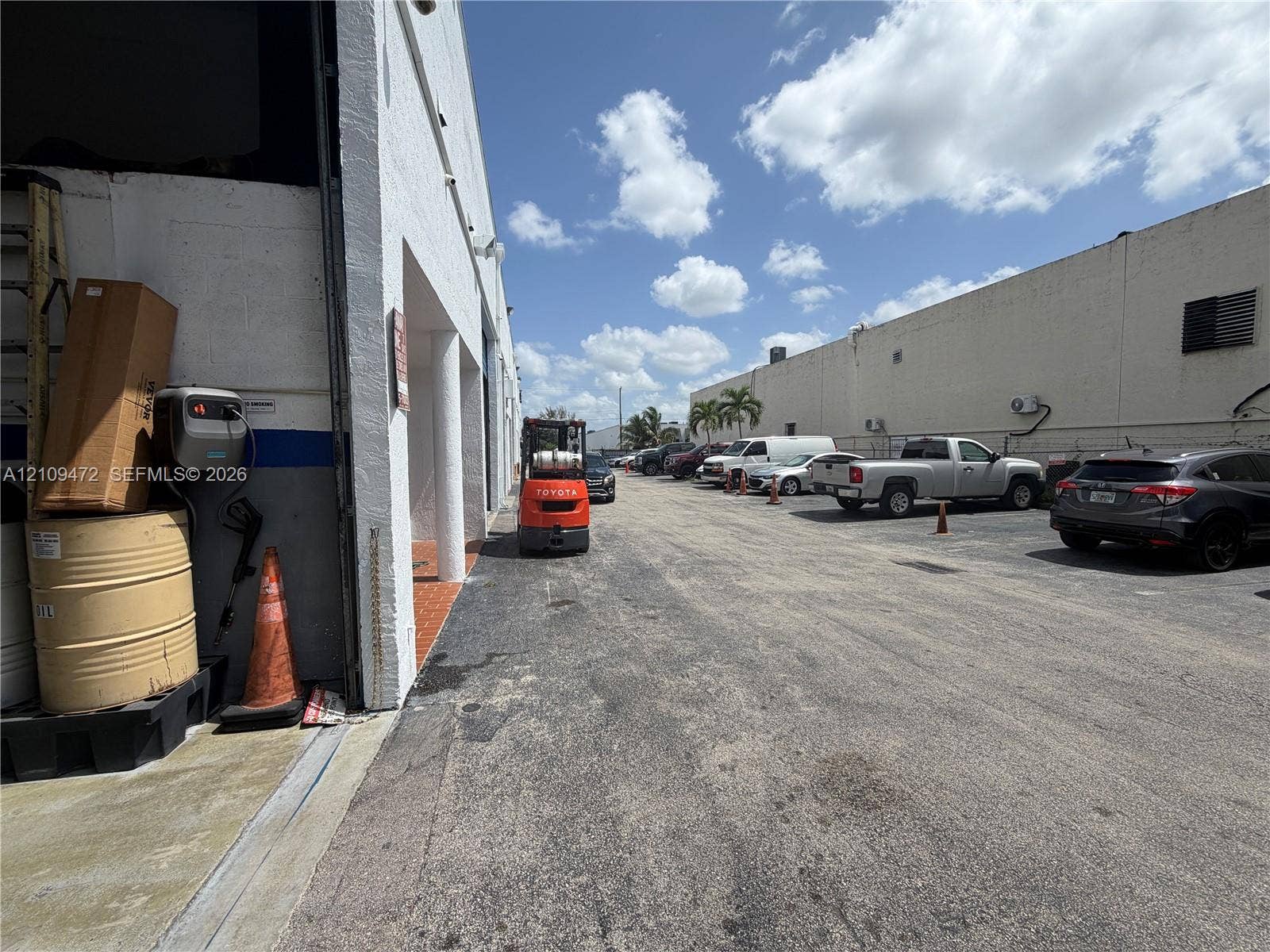 Exterior concrete perimeter with painted stucco facade and columned entryway