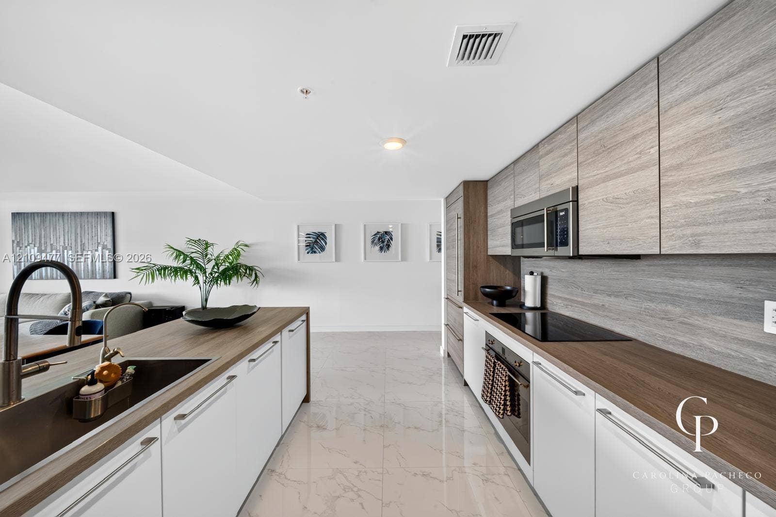 Kitchen featuring flat-panel cabinetry with wood-grain finish, polished stone-finish flooring, integrated appliances, and wood-finish countertops