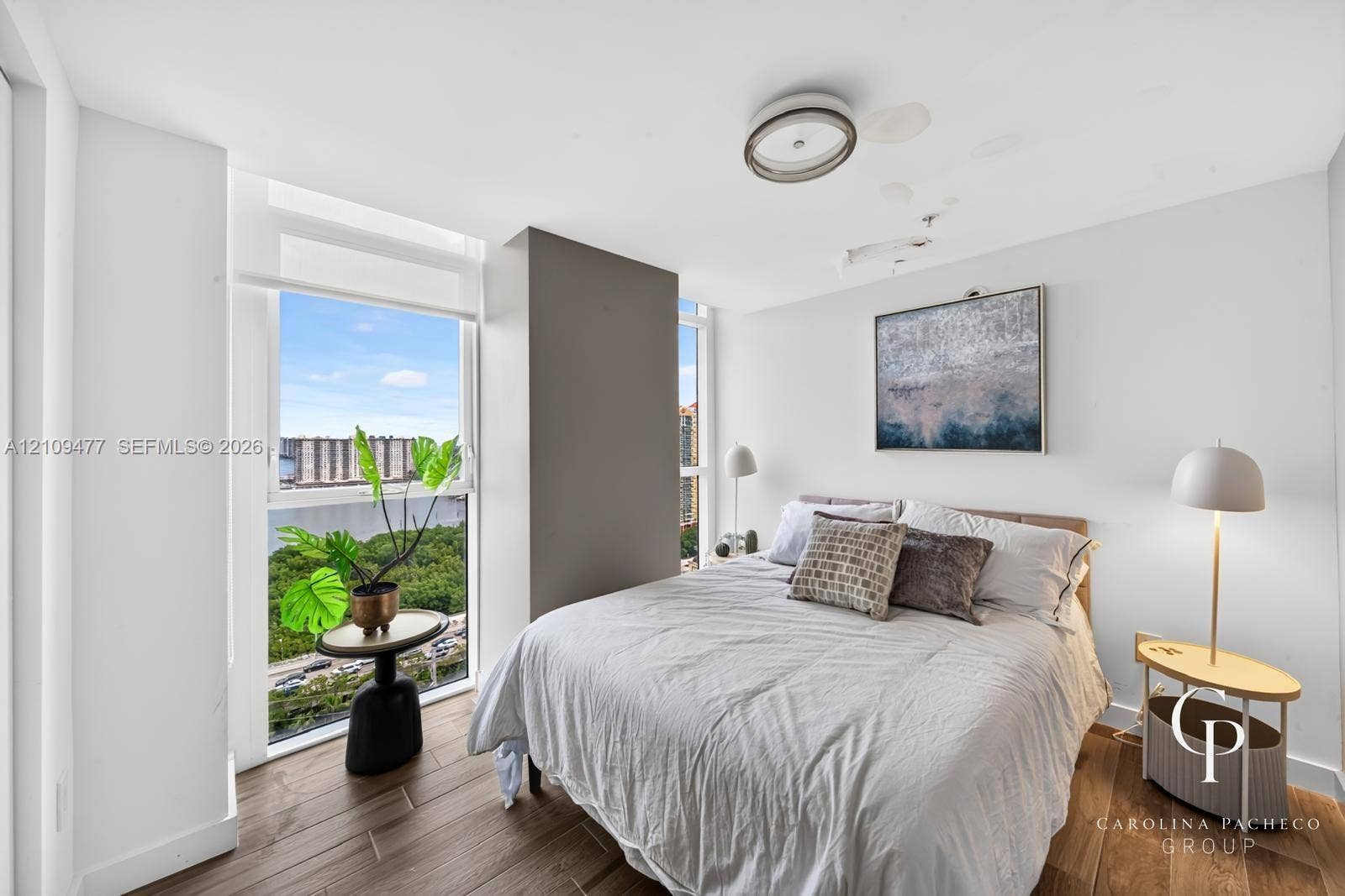 Floor-to-ceiling windows, wood-finish flooring, and recessed ceiling lighting