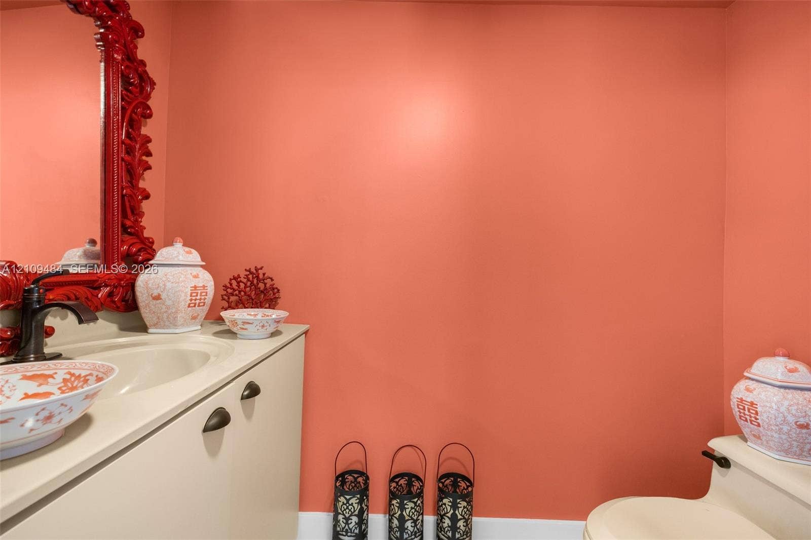 Custom vanity with an integrated basin, countertop, and dark-finished hardware