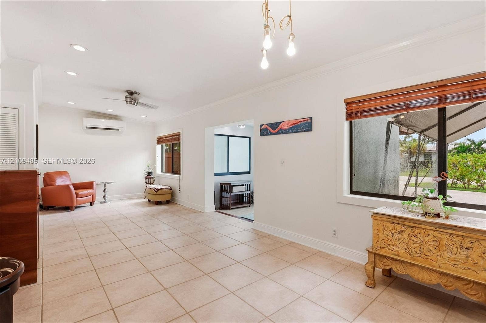 Fort Lauderdale, FL 33312 Tile flooring, recessed lighting, wall-mounted climate control unit, crown molding, and large-paned windows with wood-slat blinds
