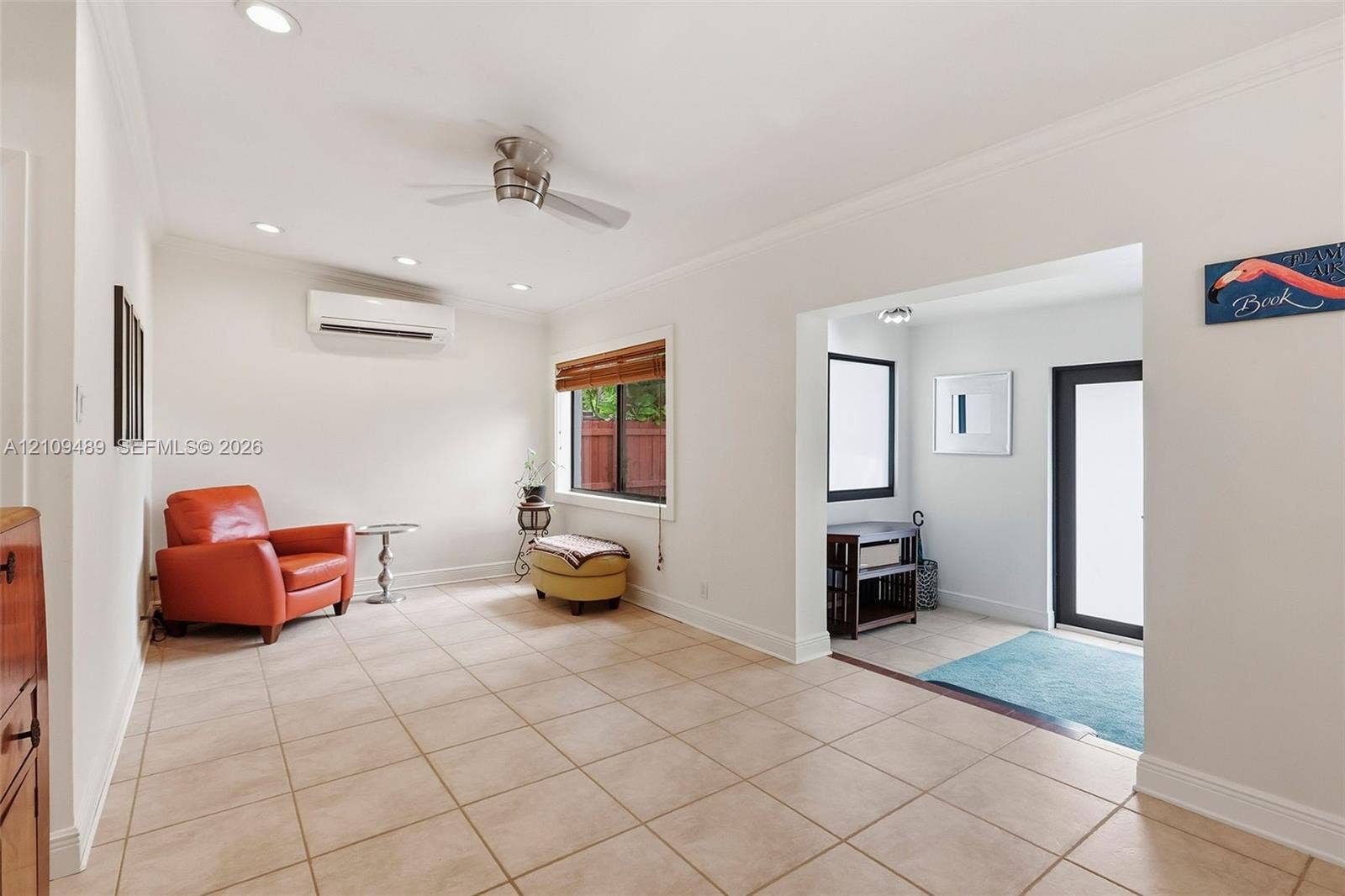 Fort Lauderdale, FL 33312 Neutral ceramic tile flooring, ceiling fan, wall-mounted climate control unit, recessed lighting, and crown molding