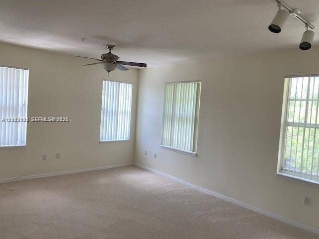 6804 W Sample Road, #6804, Coral Springs, Coral Springs, FL 33067 Neutral interior featuring neutral wall-to-wall carpeting, multiple windows with vertical blinds, a ceiling fan, and track lighting