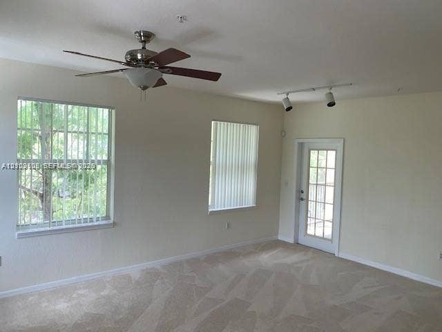 6804 W Sample Road, #6804, Coral Springs, Coral Springs, FL 33067 Neutral wall tones, carpeting, ceiling fan with light fixture, adjustable track lighting, and exterior glass-panel door