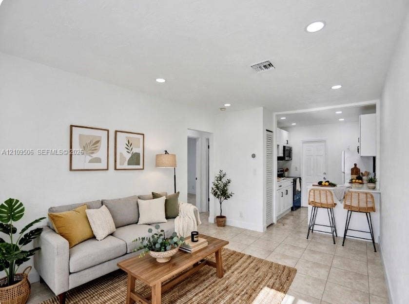 708 N 20th, #1-2, Hollywood, Hollywood, FL 33020 Staged space featuring neutral tile flooring, recessed lighting, and a breakfast bar with stone-finish countertop