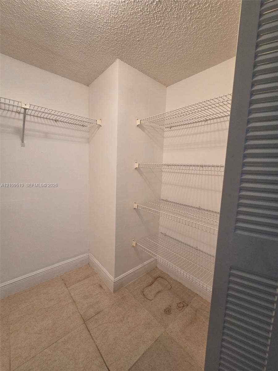 11081 NW 7th Street, #101-14, Miami, FL 33172 Walk-in closet in Primary bedroom suite is generously sized offering lots of storage.
