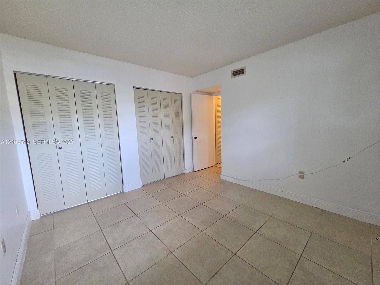 11081 NW 7th Street, #101-14, Miami, FL 33172 Room featuring ceramic tile flooring and two double-panel louvered closets