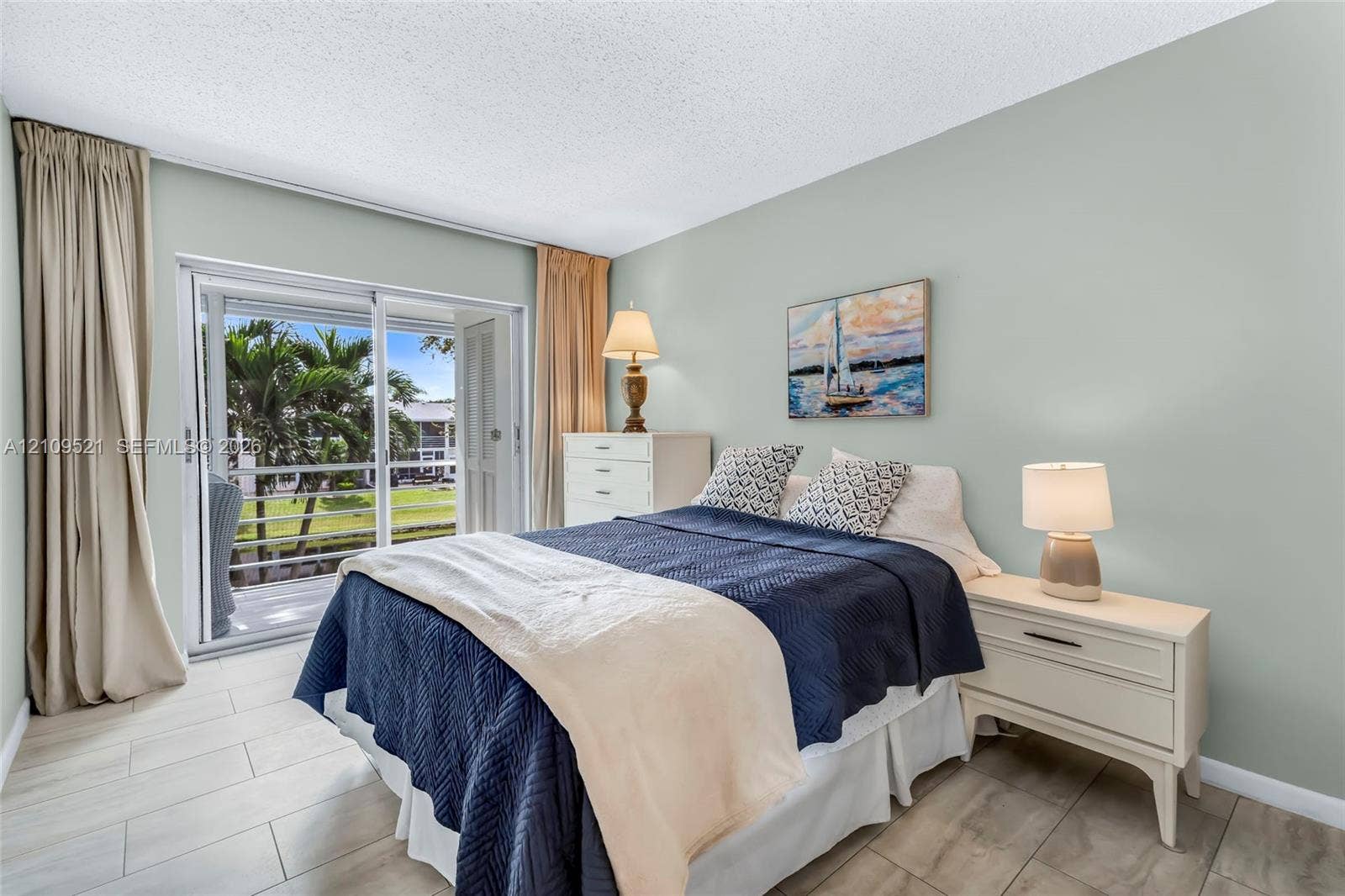 Room featuring large format tile flooring and glass sliding doors with access to an exterior balcony