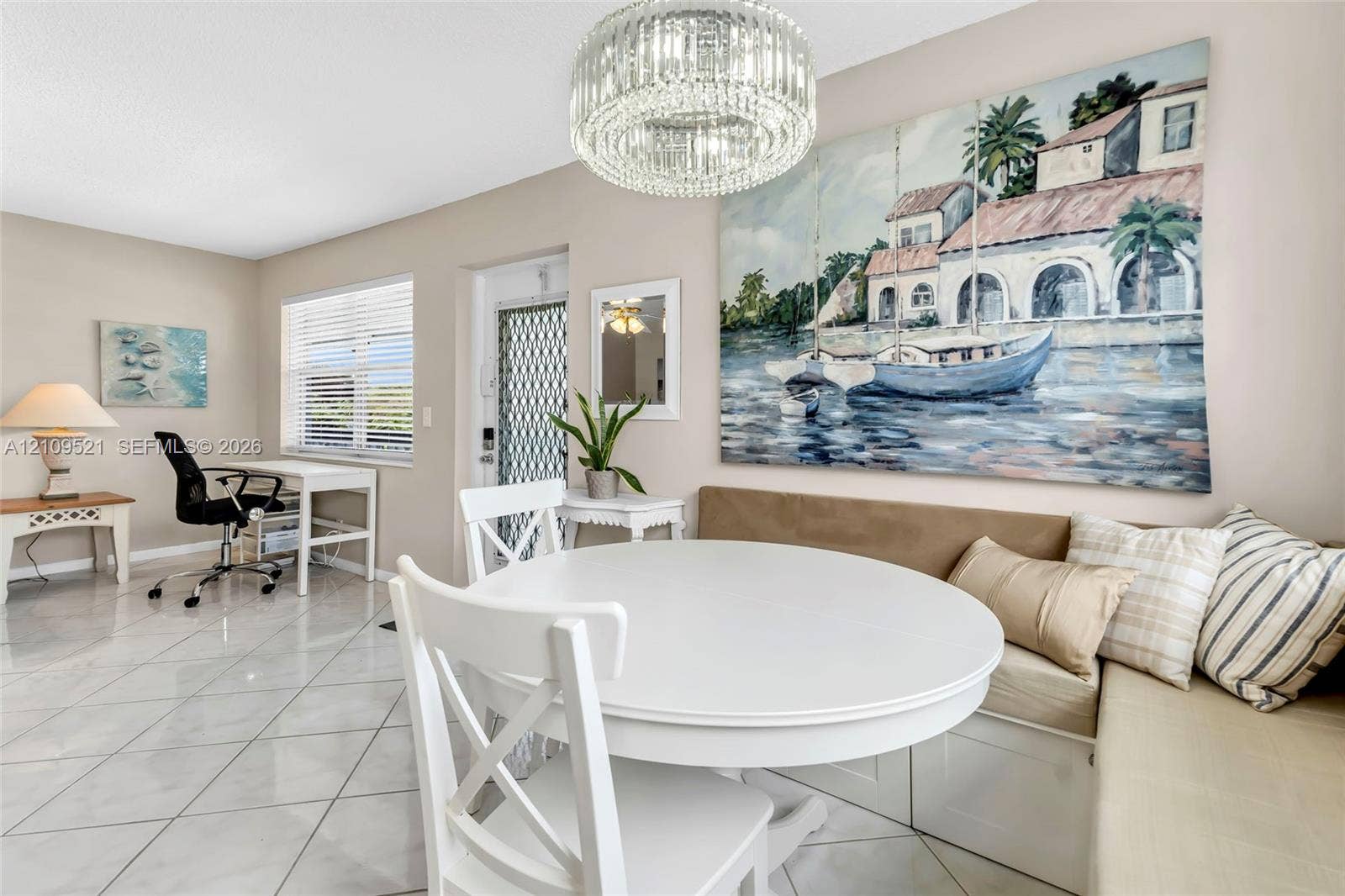 Large-format tile flooring, built-in bench seating with storage, and a tiered crystal chandelier