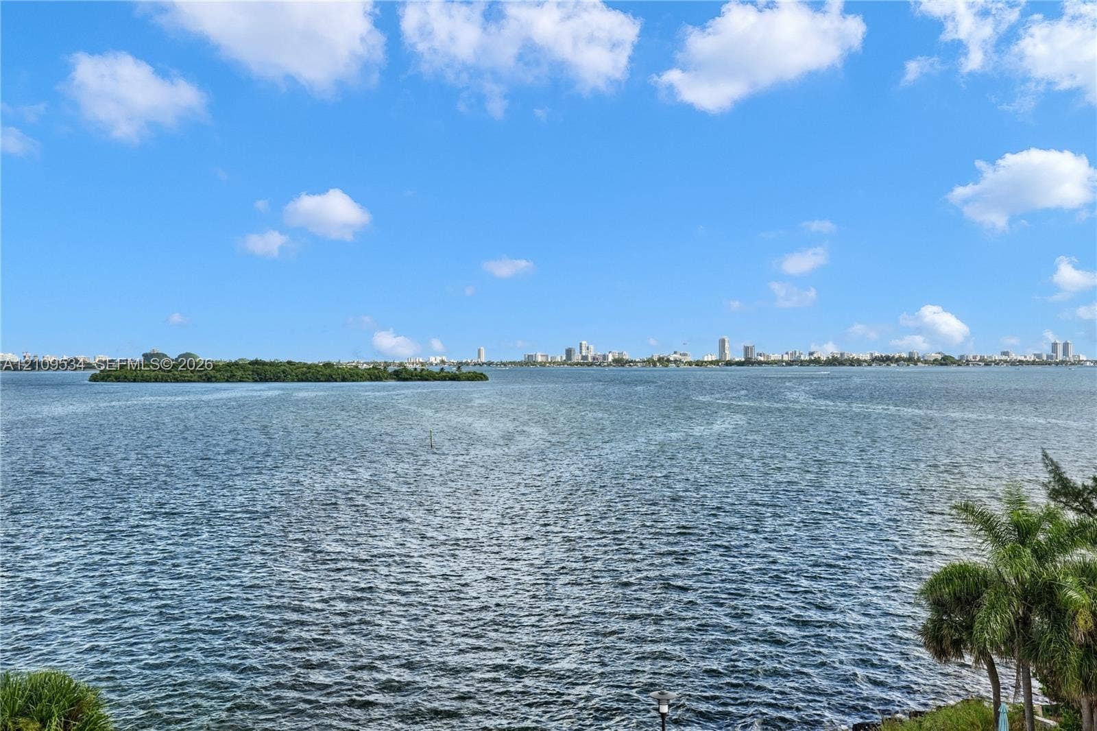 Panoramic water frontage featuring a wide-angle perspective of a bay and a distant metropolitan skyline