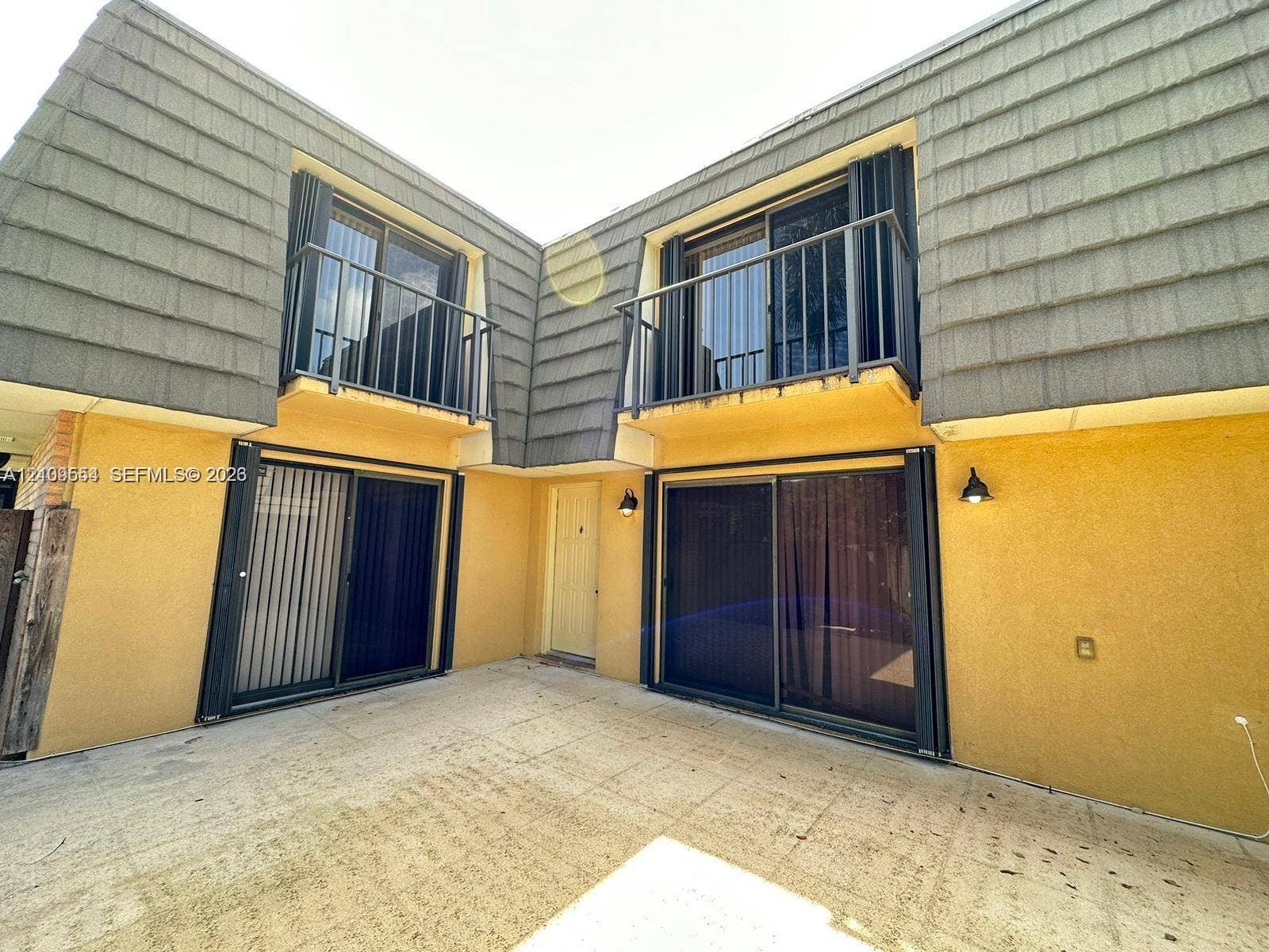 1802 18th Way, #1802, West Palm Beach, West Palm Beach, FL 33407 Exterior featuring two private balconies with metal railings, sliding glass doors on two levels, and a concrete patio area