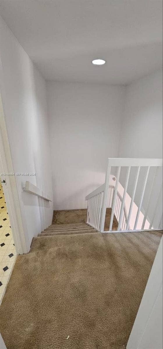 1802 18th Way, #1802, West Palm Beach, West Palm Beach, FL 33407 Staircase featuring wall-to-wall carpeting, white wooden balustrade, mounted handrail, and recessed ceiling lighting