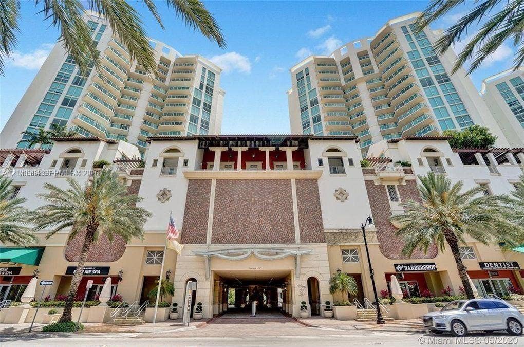 200 Sunny Isles Boulevard, #2-604, Sunny Isles Beach, Sunny Isles Beach, FL 33160 Multi-story high-rise architecture featuring glass balconies, brick-accented exterior masonry, arched entryways, and integrated ground-floor commercial spaces