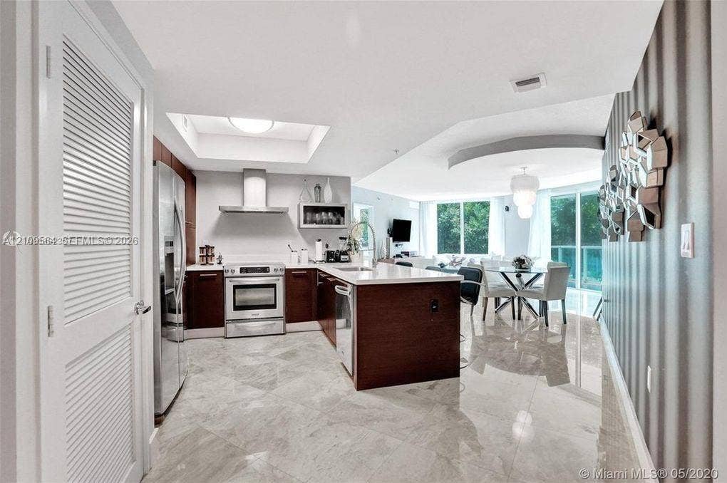 200 Sunny Isles Boulevard, #2-604, Sunny Isles Beach, Sunny Isles Beach, FL 33160 Kitchen featuring dark wood-finish cabinetry, quartz countertops, stainless steel appliances, recessed lighting, and tile flooring
