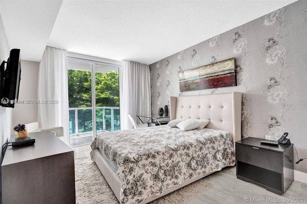 200 Sunny Isles Boulevard, #2-604, Sunny Isles Beach, Sunny Isles Beach, FL 33160 Floor-to-ceiling glass sliding doors opening to a balcony, patterned accent wall covering, and neutral light-toned flooring