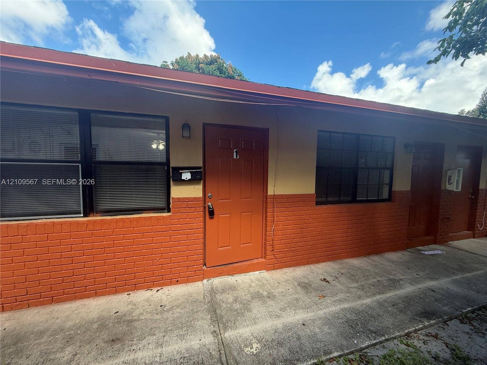 1132 NE 5th Avenue, #1, Fort Lauderdale, Fort Lauderdale, FL 33304 Exterior featuring a two-tone painted facade, lower-level brick masonry, multi-pane windows, and a concrete walkway