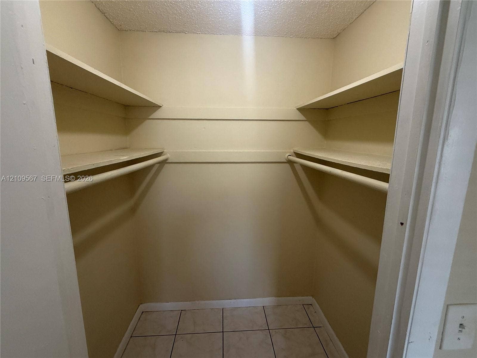 1132 NE 5th Avenue, #1, Fort Lauderdale, Fort Lauderdale, FL 33304 Walk-in storage space featuring ceramic tile flooring, built-in shelving, and dual hanging rods