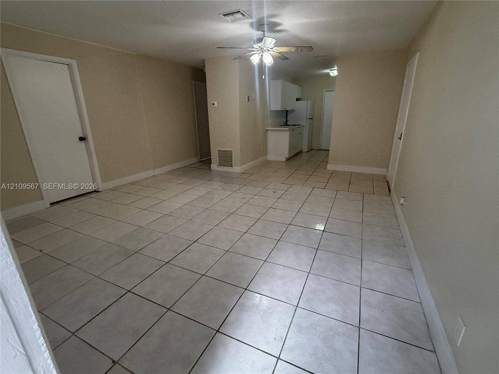 1132 NE 5th Avenue, #1, Fort Lauderdale, Fort Lauderdale, FL 33304 Neutral-toned interior featuring ceramic tile flooring, ceiling-mounted light fixture with fan, and white cabinetry