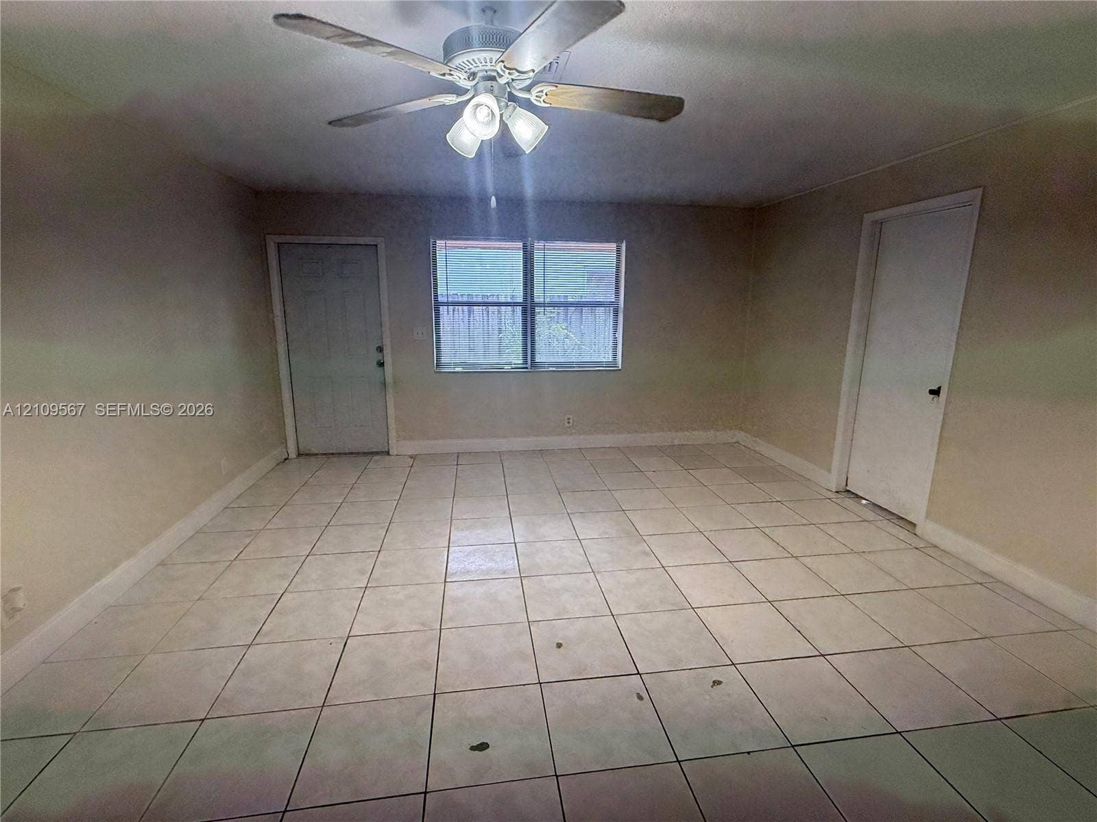 1132 NE 5th Avenue, #1, Fort Lauderdale, Fort Lauderdale, FL 33304 Ceramic tile flooring, neutral wall tones, multi-pane window, and a central ceiling fan with integrated lighting