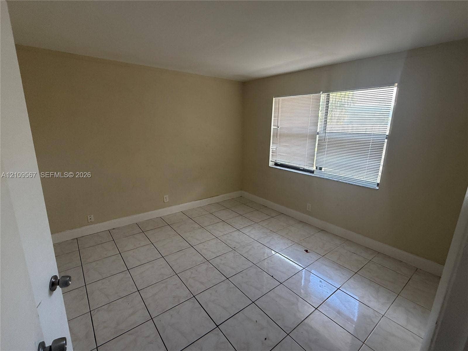 1132 NE 5th Avenue, #1, Fort Lauderdale, Fort Lauderdale, FL 33304 Room featuring large-format ceramic tile flooring and multi-pane window with horizontal blinds
