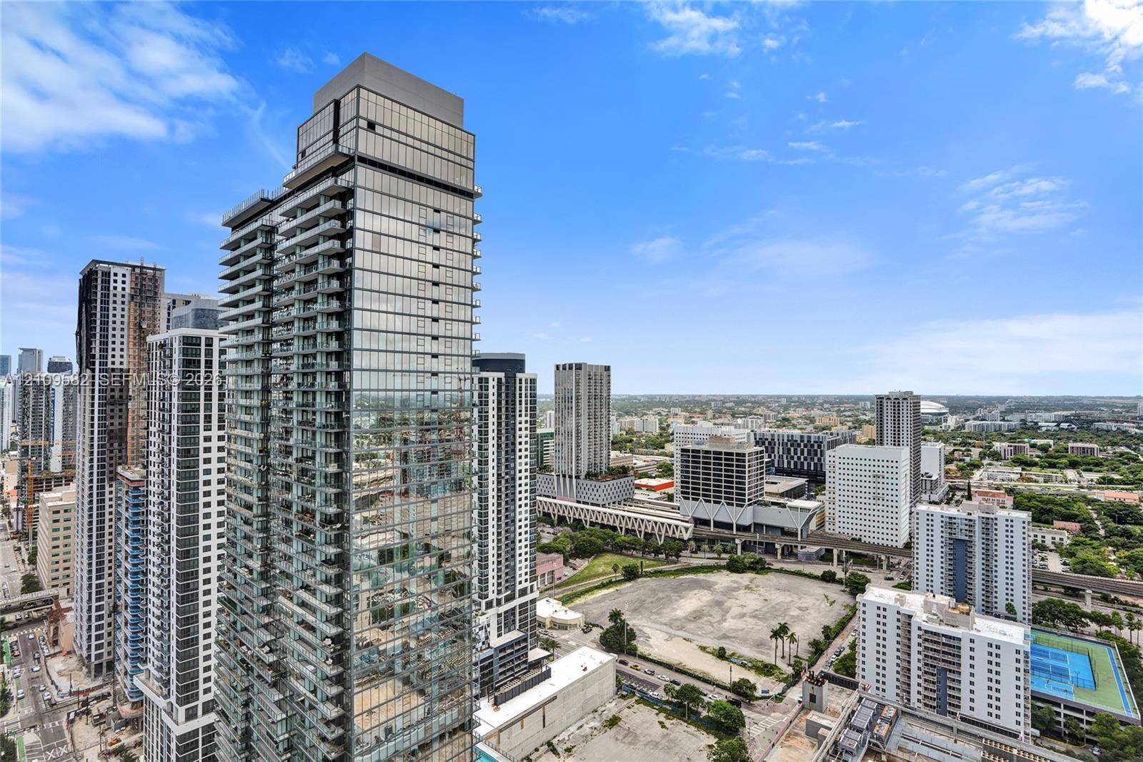 High-rise glass facade featuring floor-to-ceiling windows and recessed balconies