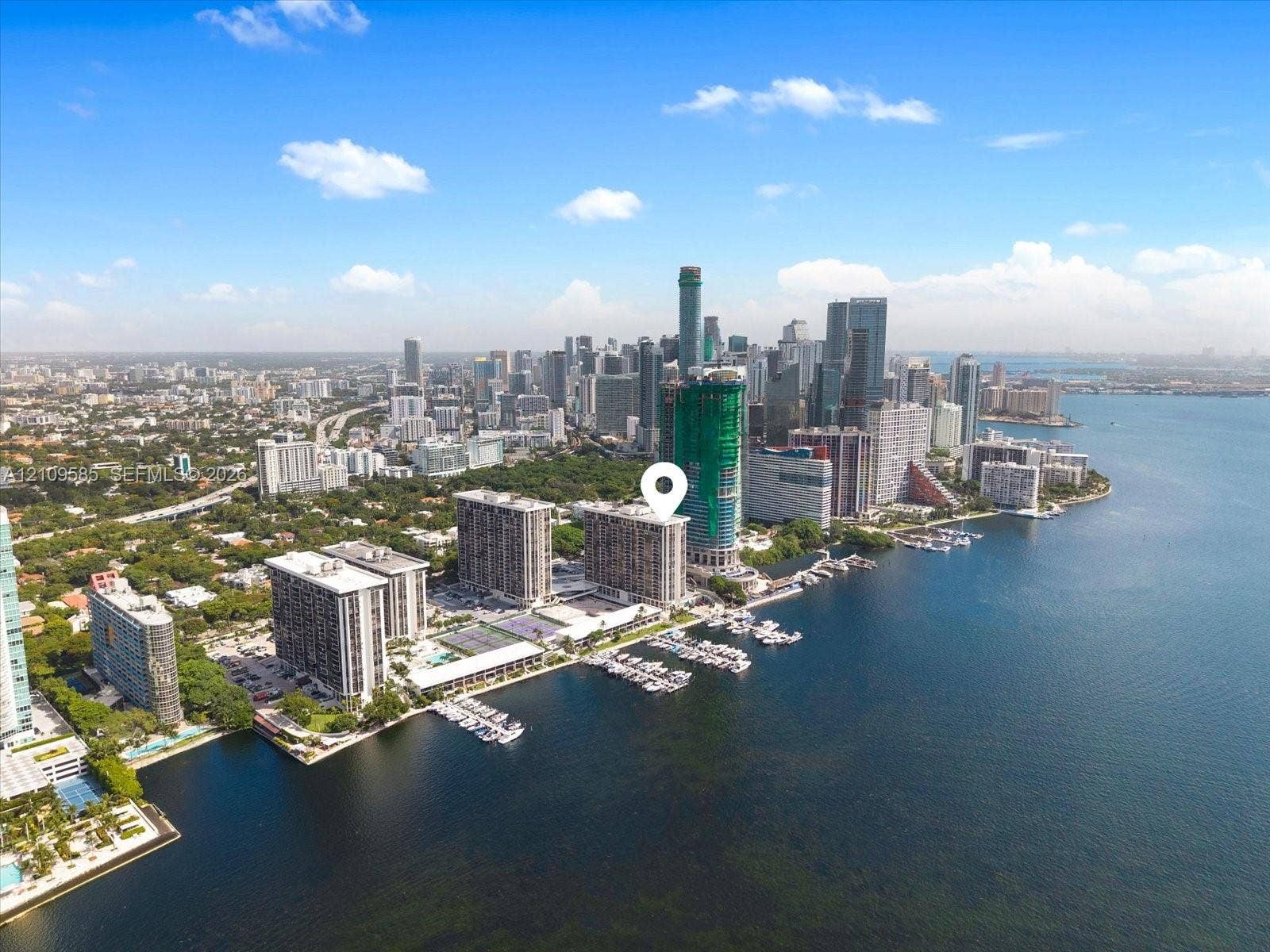 1865 Brickell Avenue, #APHVII, Miami, FL 33129 Aerial perspective of waterfront high-rise property featuring deep-water marina access, proximity to metropolitan skyline, and direct coastal frontage