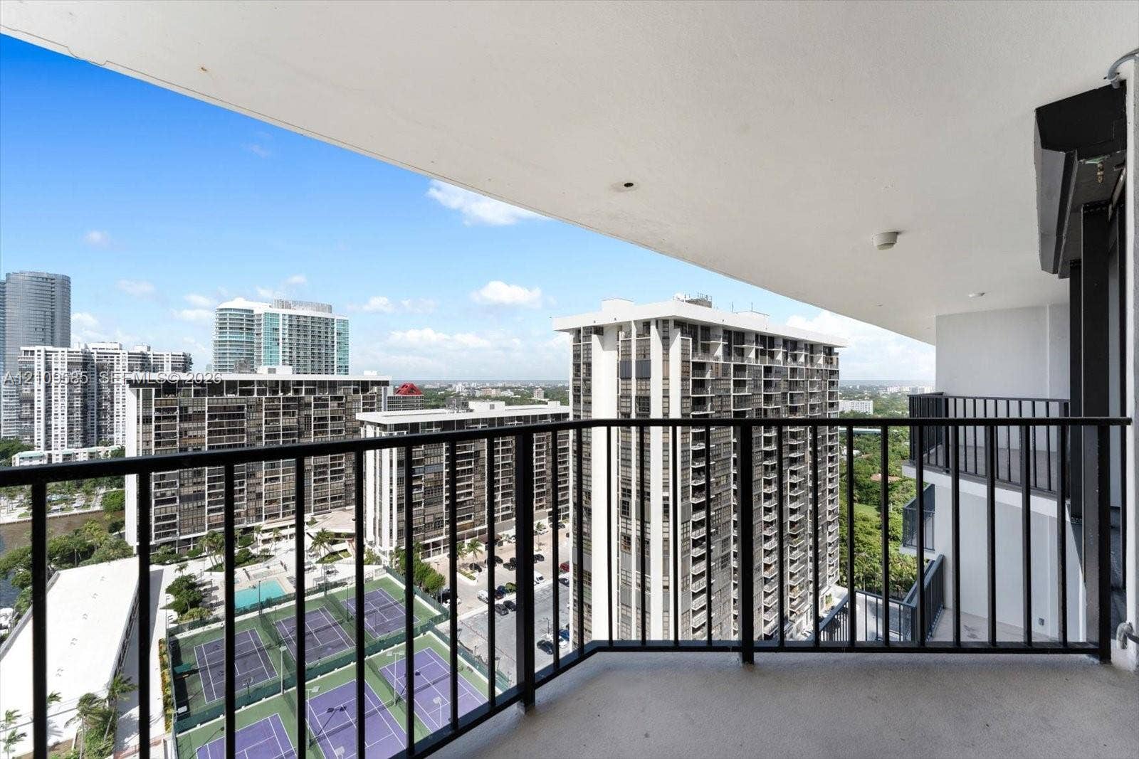 1865 Brickell Avenue, #APHVII, Miami, FL 33129 Covered balcony featuring black metal railings and overhead lighting