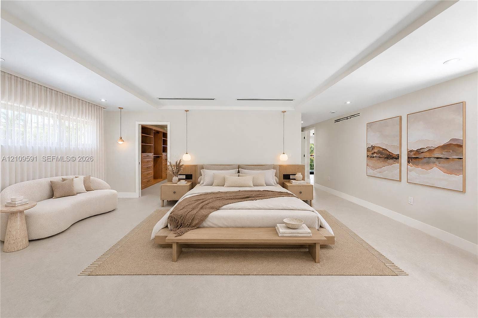 864 NE 91st Terrace, Miami Shores, FL 33138 Virtually Staged: Spacious room featuring a recessed tray ceiling, neutral wall-to-wall flooring, built-in wooden headboard with integrated side tables, pendant lighting, and a walk-in closet with custom wooden shelving