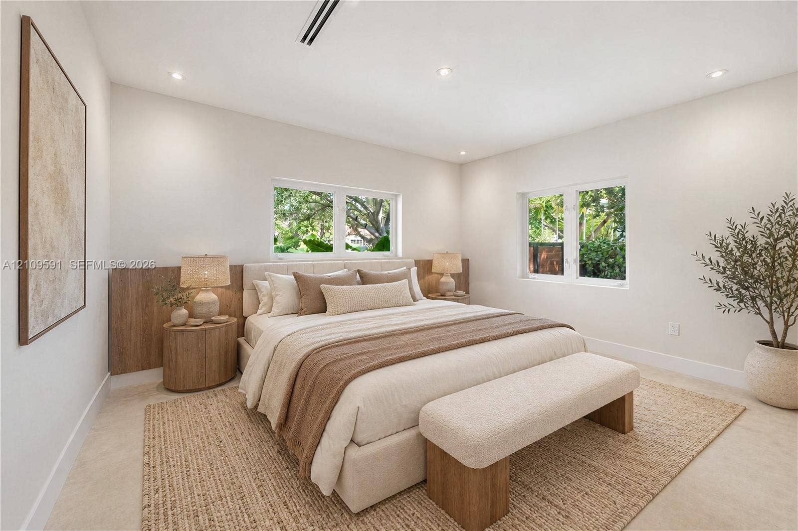 864 NE 91st Terrace, Miami Shores, FL 33138 Virtually Staged: Neutral-toned room featuring wood-finish wall paneling, light-toned flooring, recessed lighting, and multiple windows